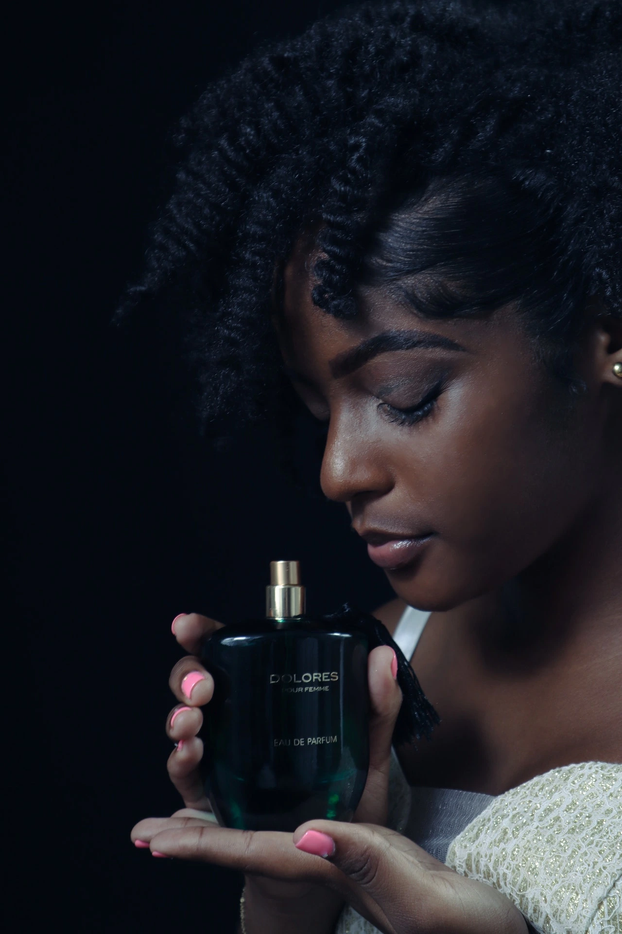 Woman smelling perfume bottle